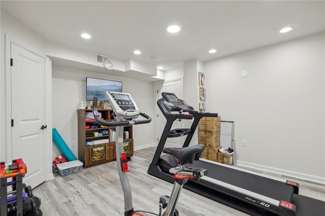 workout room with light hardwood / wood-style floors