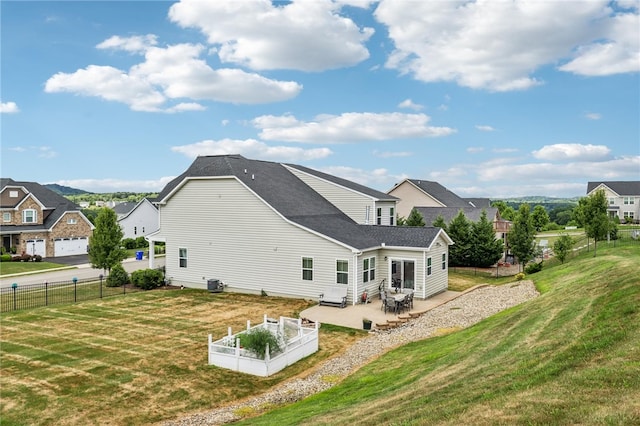 rear view of house with a patio and a yard