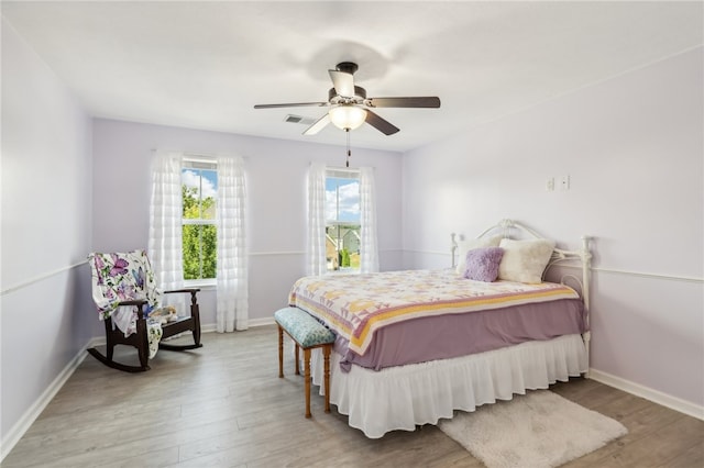 bedroom featuring wood-type flooring and ceiling fan