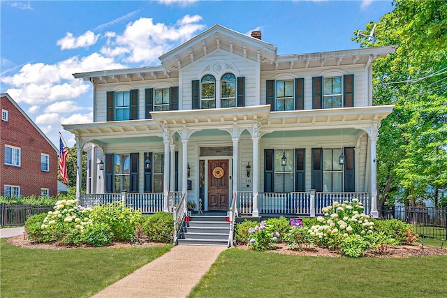 italianate house with a front lawn and covered porch