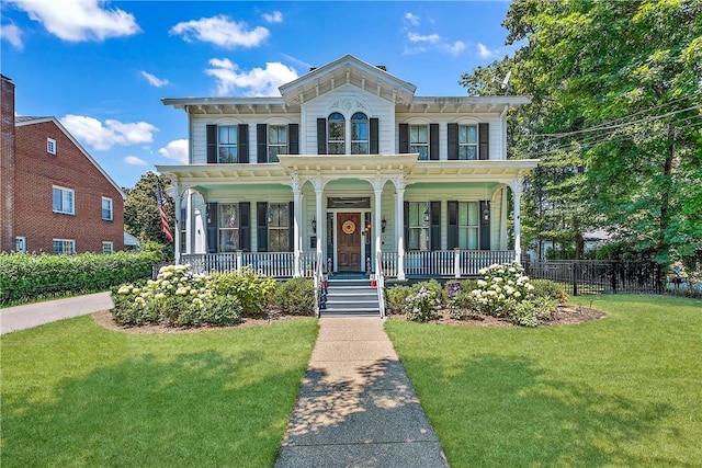 italianate home with a front yard and a porch