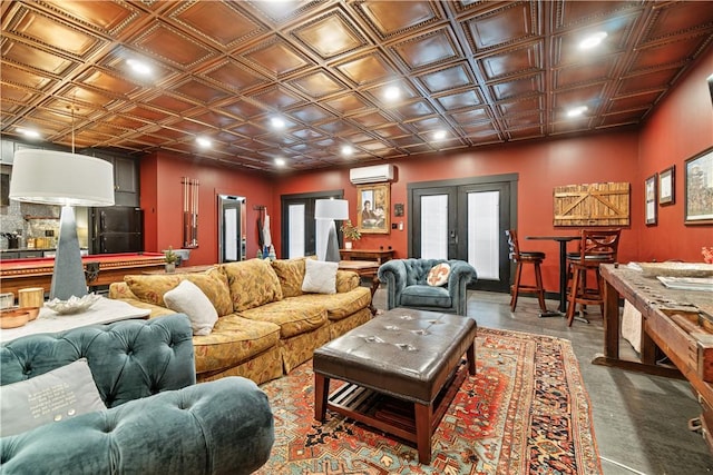 living room with concrete floors, a wall mounted AC, pool table, and french doors