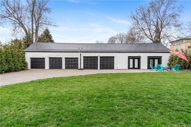 garage with french doors and a yard