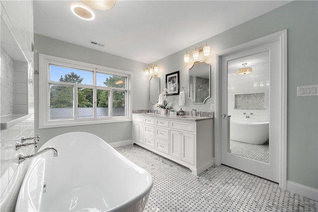 bathroom with a tub and vanity