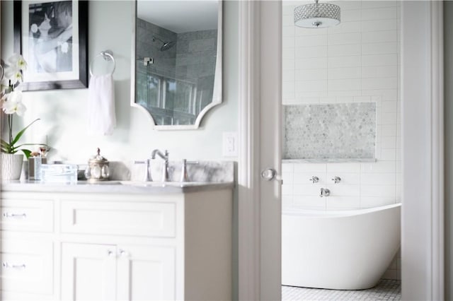 bathroom with tile patterned floors, vanity, and shower with separate bathtub