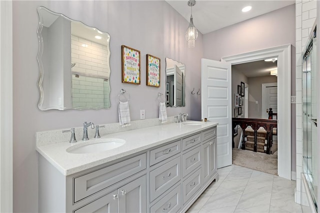 bathroom featuring an enclosed shower and vanity