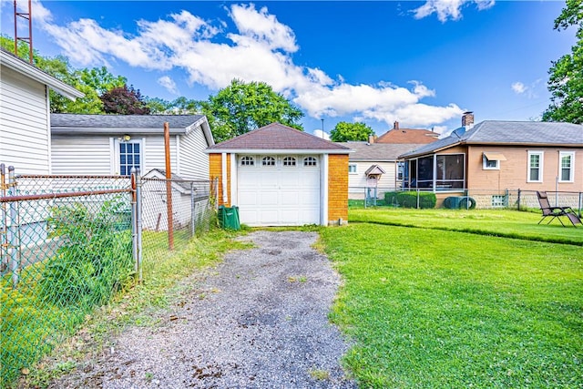 view of front of property featuring an outbuilding, a garage, and a front lawn