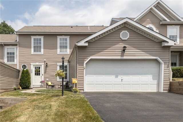 view of front of property featuring a garage and a front yard