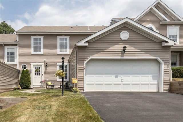 view of front facade with a front yard and a garage