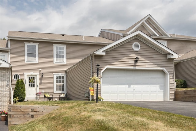 view of front of home featuring a garage and a front yard