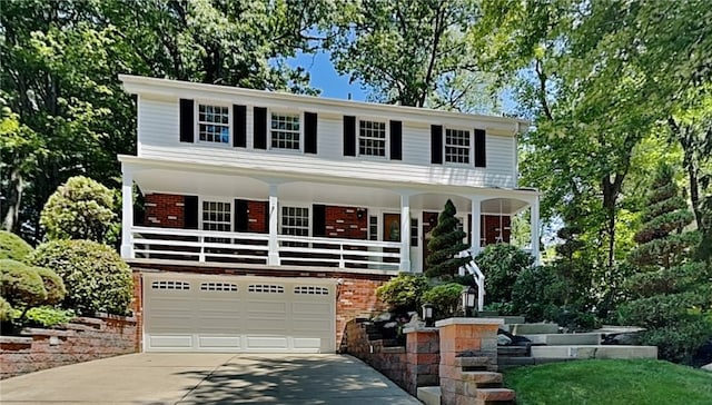 view of front of home featuring covered porch and a garage