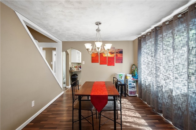 dining area featuring a notable chandelier and dark hardwood / wood-style floors