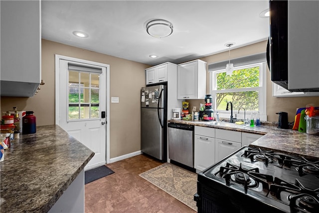 kitchen featuring white cabinetry, a healthy amount of sunlight, stainless steel appliances, and tile patterned flooring