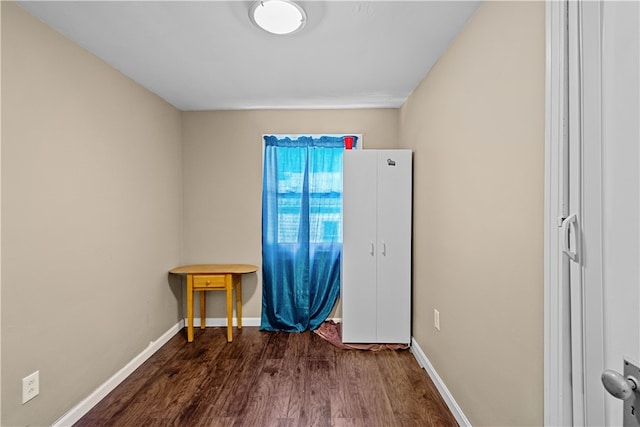 spare room featuring dark wood-type flooring