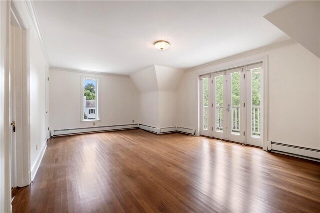 bonus room with a baseboard heating unit, wood-type flooring, and french doors