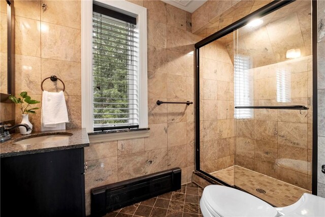 bathroom featuring vanity, tile patterned flooring, and tile walls