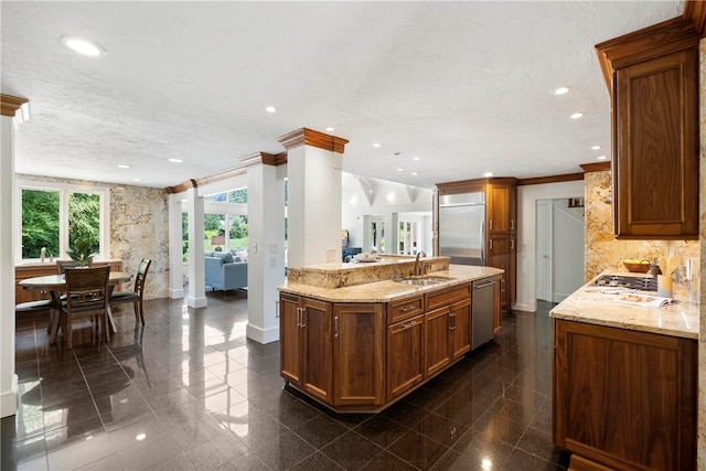 kitchen featuring sink, dark tile patterned floors, stainless steel appliances, and ornamental molding