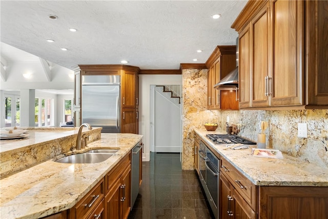 kitchen featuring tasteful backsplash, stainless steel appliances, sink, dark tile patterned flooring, and wall chimney exhaust hood