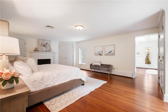 bedroom featuring hardwood / wood-style flooring, a closet, and ornamental molding