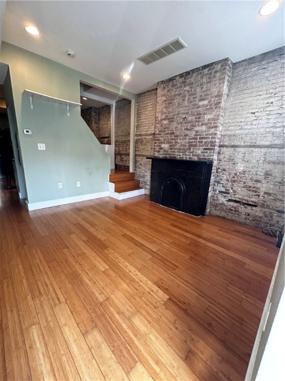 unfurnished living room featuring wood-type flooring