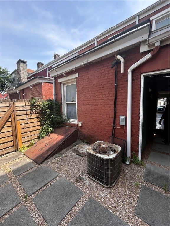 view of side of home with central AC