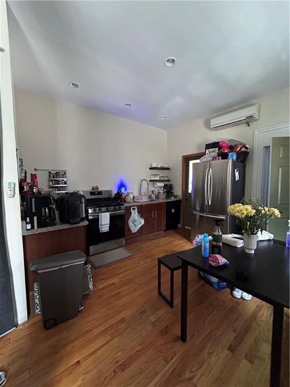 interior space featuring wood-type flooring, a wall unit AC, and sink