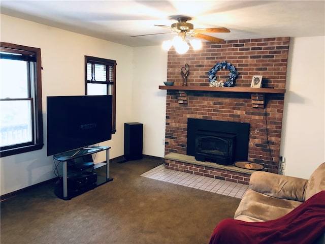 carpeted living room with ceiling fan, brick wall, and a brick fireplace