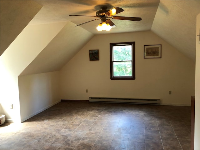 bonus room with tile patterned flooring, a textured ceiling, ceiling fan, baseboard heating, and vaulted ceiling