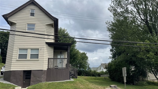 view of side of home with a lawn