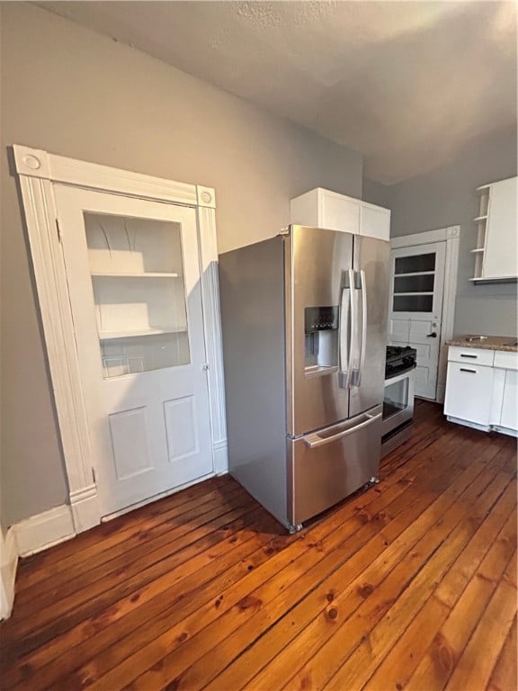 kitchen featuring appliances with stainless steel finishes, white cabinetry, and dark hardwood / wood-style floors