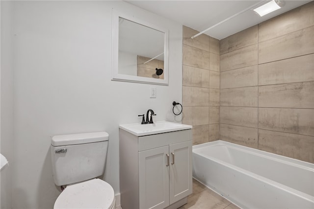 full bathroom featuring tiled shower / bath combo, tile patterned floors, toilet, and vanity