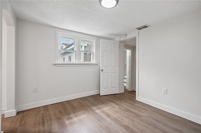 unfurnished room featuring hardwood / wood-style flooring