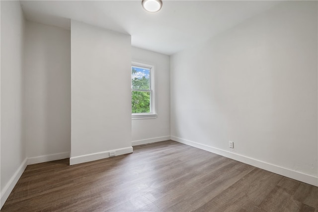 empty room with dark hardwood / wood-style flooring