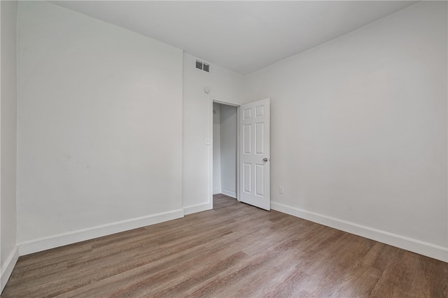 unfurnished room featuring hardwood / wood-style floors