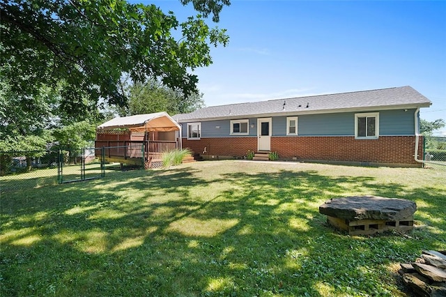 back of property with a lawn and a gazebo