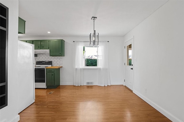 kitchen featuring light hardwood / wood-style flooring, green cabinets, hanging light fixtures, backsplash, and range with electric cooktop