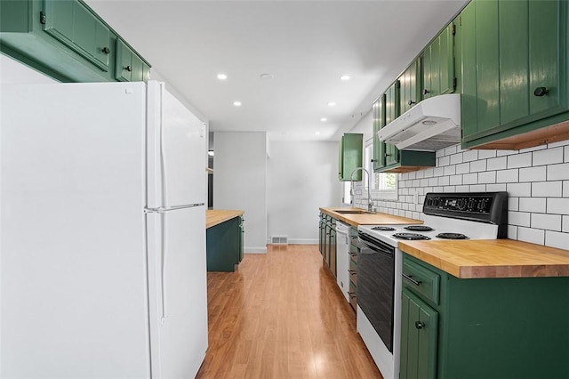 kitchen featuring green cabinetry, white appliances, and wood counters