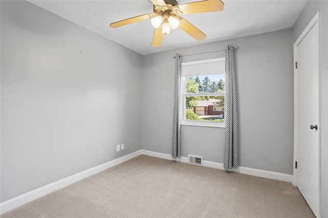 unfurnished room featuring light colored carpet and ceiling fan