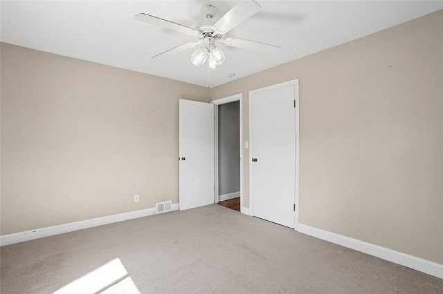 unfurnished bedroom featuring ceiling fan and carpet