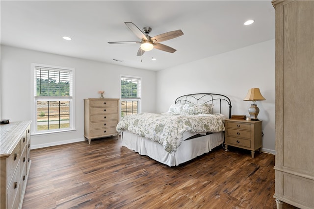 bedroom with dark hardwood / wood-style flooring, multiple windows, and ceiling fan