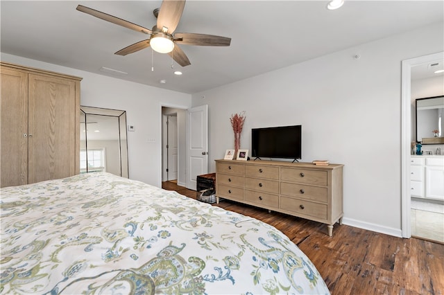 bedroom with dark hardwood / wood-style flooring, ensuite bath, and ceiling fan