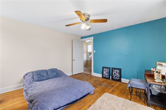 bedroom with wood-type flooring and ceiling fan