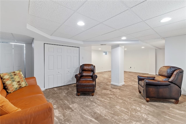 sitting room with a drop ceiling