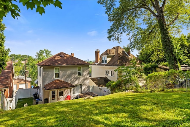 rear view of house with a lawn