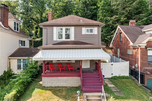 view of front of home with covered porch and a front yard