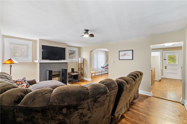 living room with wood-type flooring and a fireplace