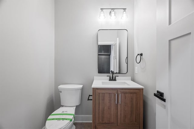 bathroom featuring vanity and toilet