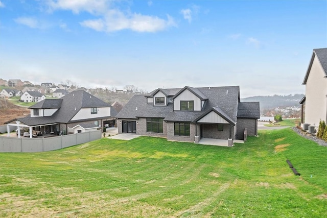 rear view of property with a patio area and a yard