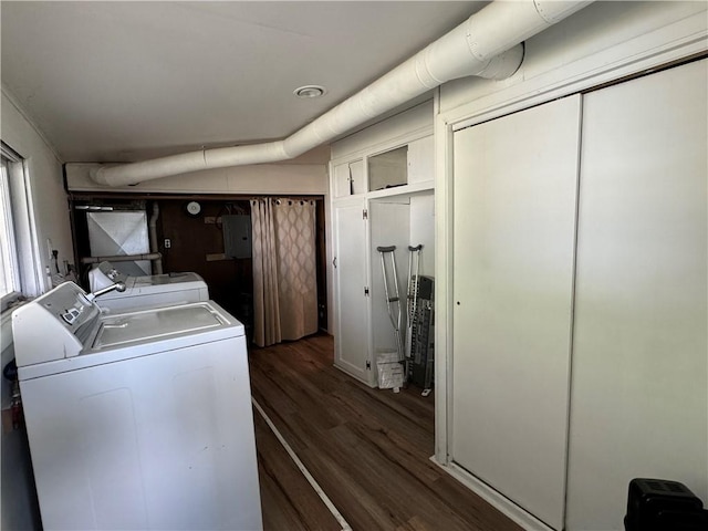 washroom with dark hardwood / wood-style flooring, washing machine and dryer, and electric panel