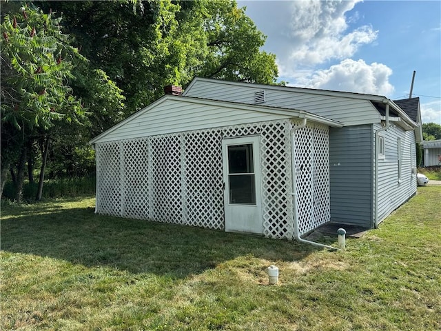 view of outbuilding featuring a yard